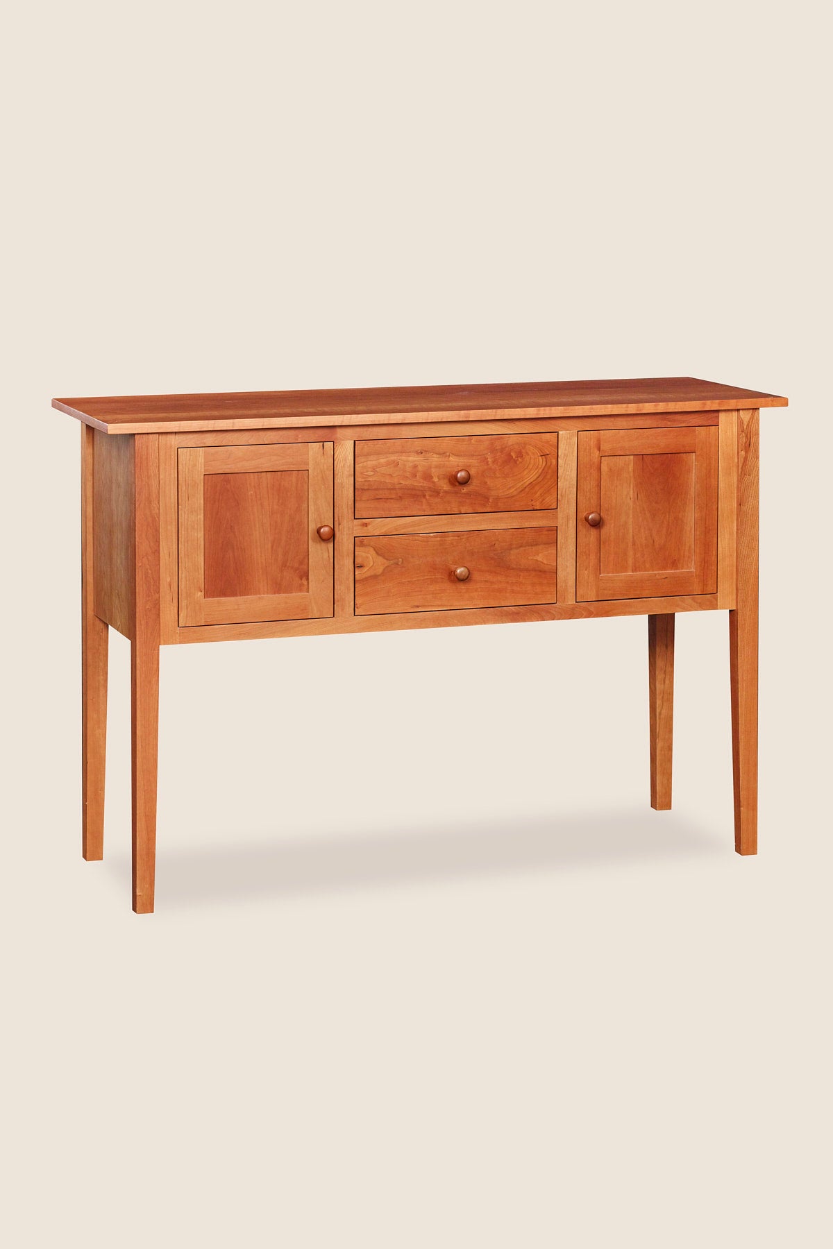 Shaker style storage furniture with two centered drawers and two doors, made in cherry wood